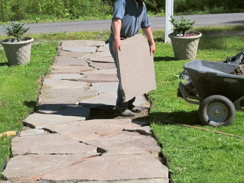 To level a stone in the walk, first you must remove it.