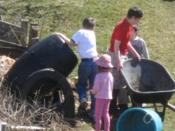 Children turning the compost pile