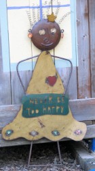 Image of metal garden ornament, figure with sign that reads never be too happy