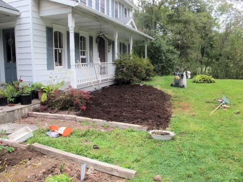 The rotted manure has been raked smooth over this new garden bed.