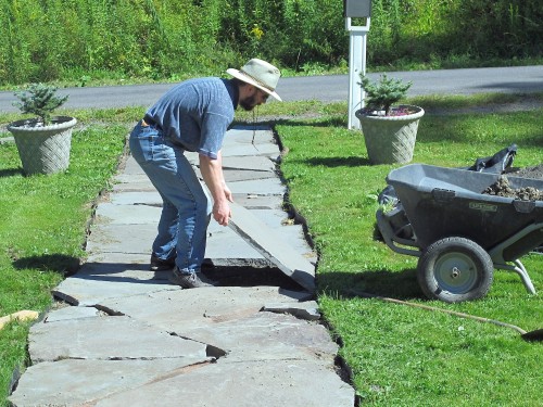 Carefully replace the stone in the walk after the base has been leveled.