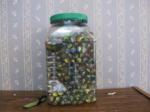 Marbles from the dollar store can be used to hold floral arrangements in place.