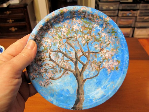 blossoming apple tree painted on a clay saucer