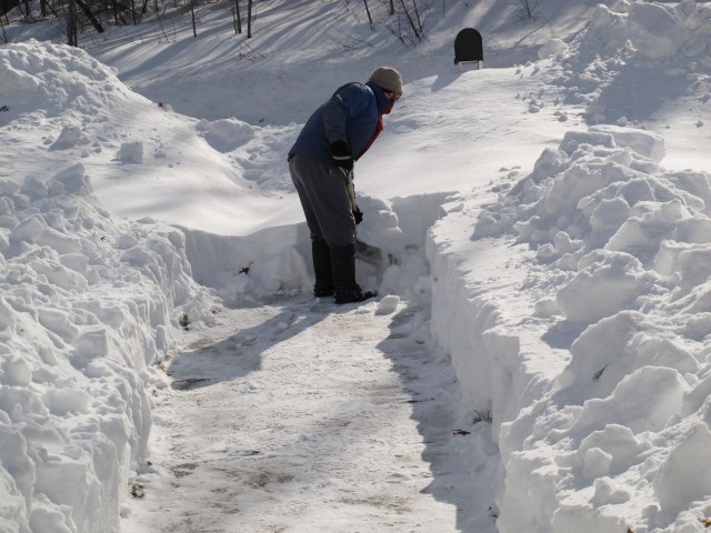 Man shoveling deep snow